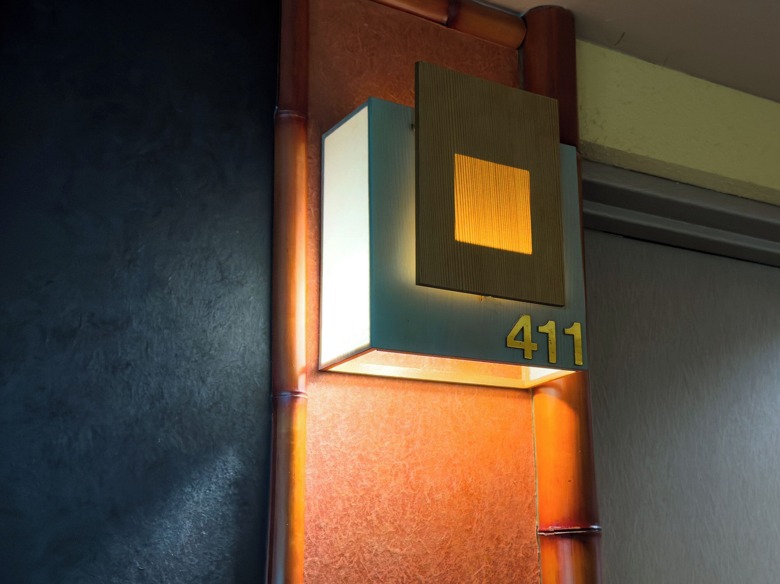 A wall-mounted sign with the number 411, indicating a room or location.