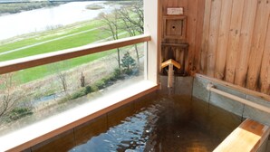 A wooden interior with a window overlooking a river and a bridge. - Kangetsuen (Otofuke)