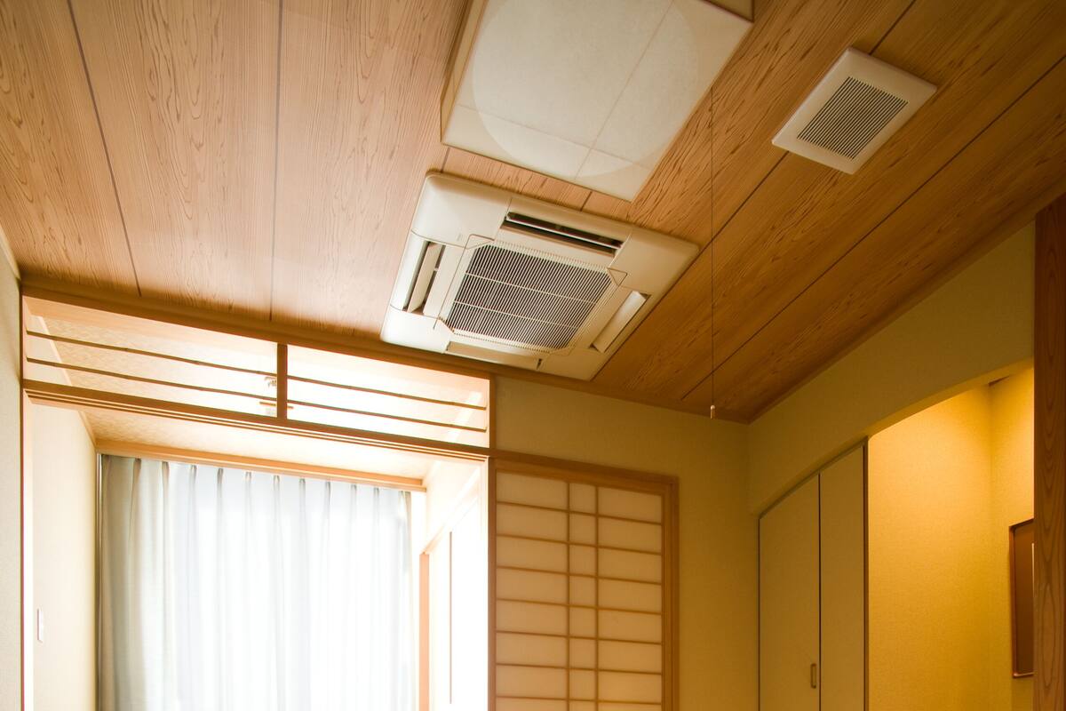 A traditional Japanese room with tatami flooring, a low table, and two tatami mats.