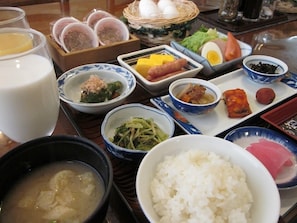 A variety of dishes including rice, soup, and several small bowls of food, likely part of a meal setting. - Kitaguchi Hotel (Kitami)