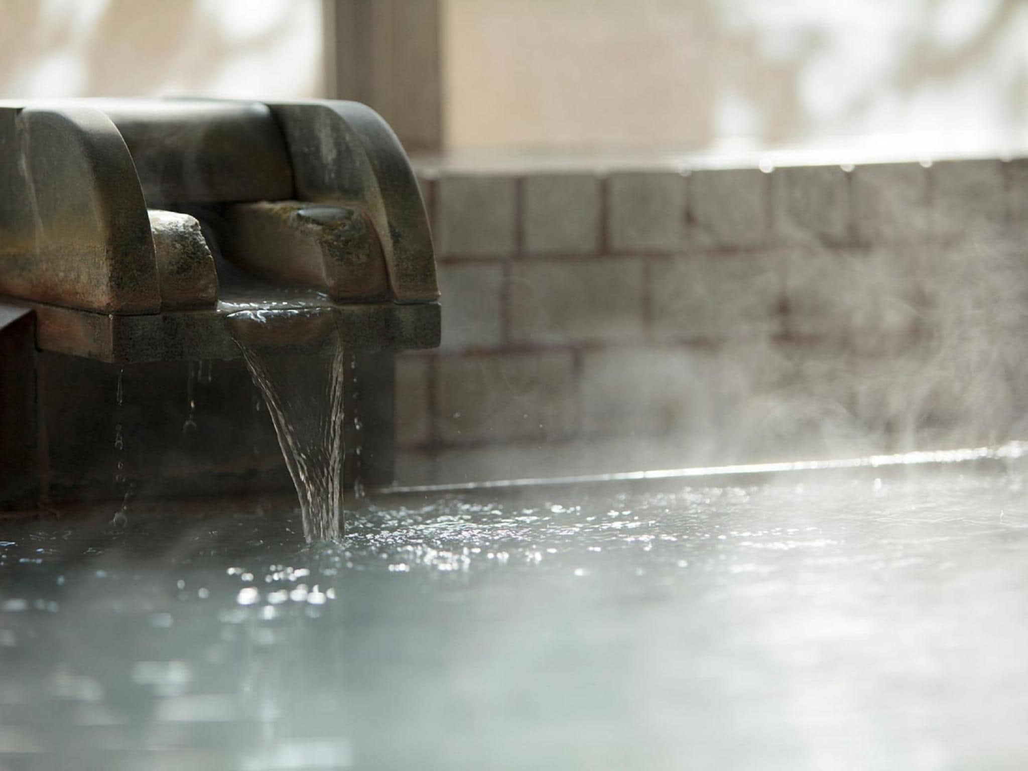 Un chorro de agua vertiéndose en una piscina.