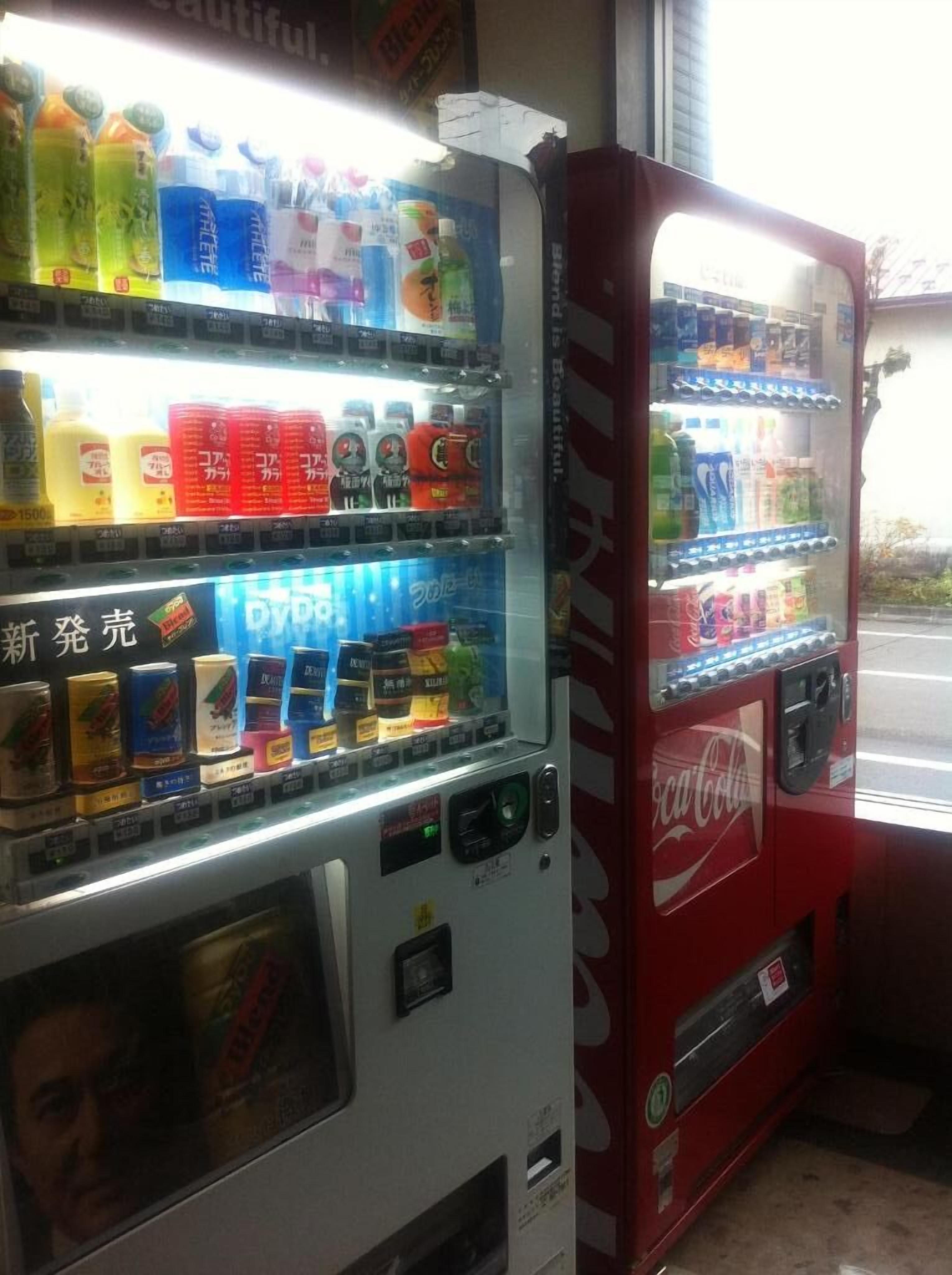 Two vending machines with various beverages and snacks.