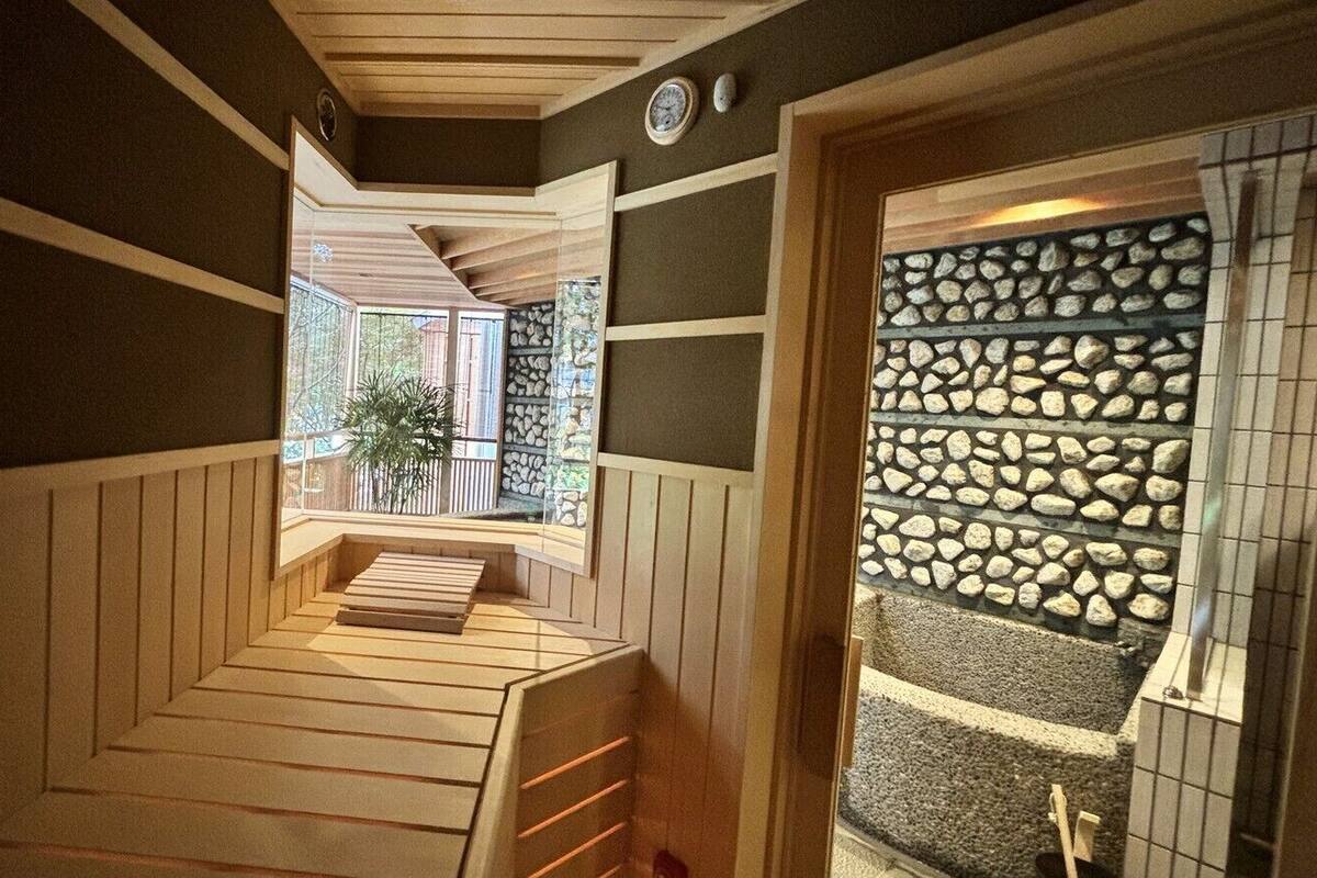 A wooden staircase leading to a balcony with a view of the outdoors.