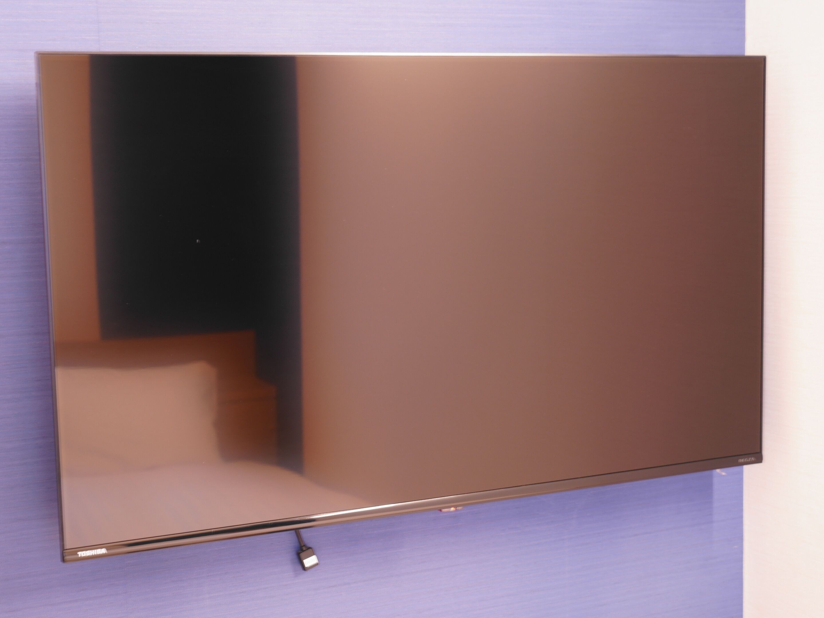 A flat-screen TV mounted on a wall.