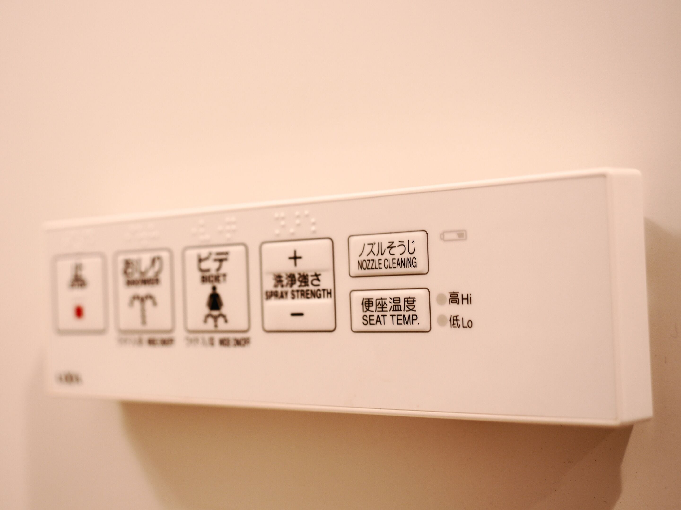 A control panel with various buttons and labels, including "NOZZLE CLEANING" and "SPRAY STRENGTH".