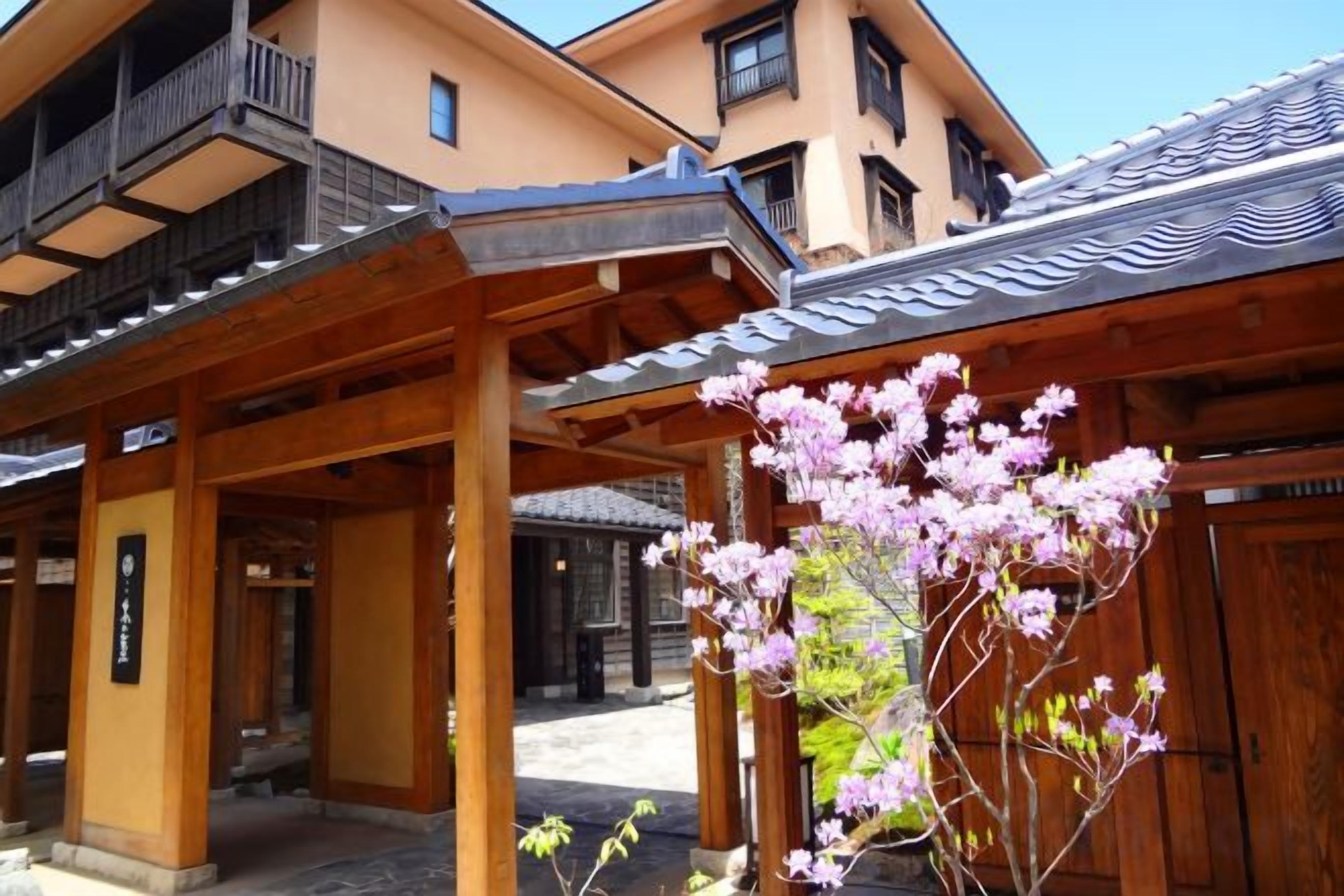 A traditional Japanese building with wooden structures and a covered walkway.