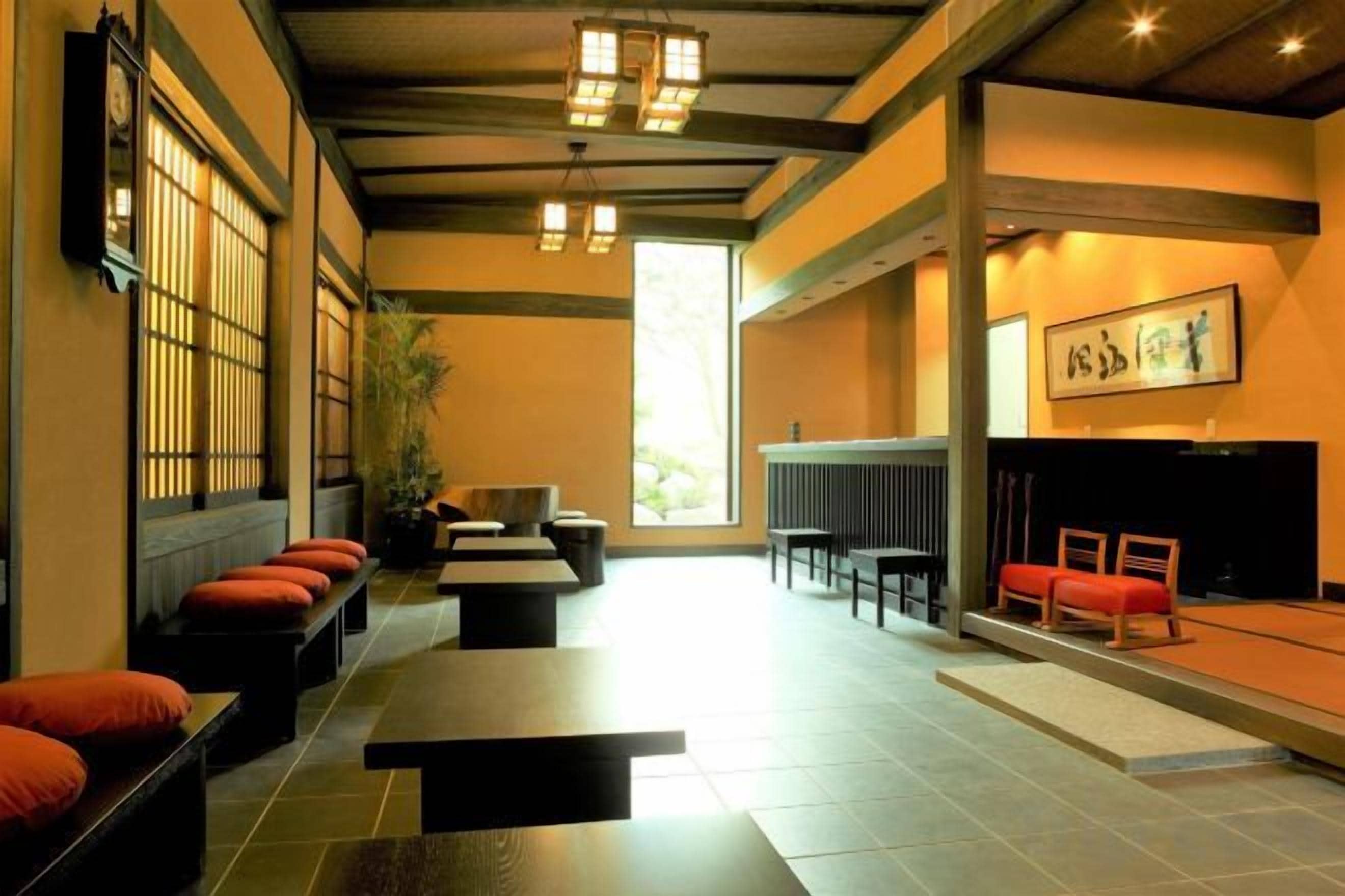 A traditional interior with seating, a fireplace, and a view of the outdoors.