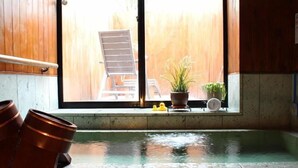A room with a large window, a wooden chair outside, and two potted plants on the windowsill. - Petit Pension La'ha-yu From Tochigi (Nasu)