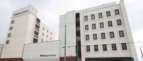 A multi-story building with the sign "Wakkanai Sun Hotel" on the facade.