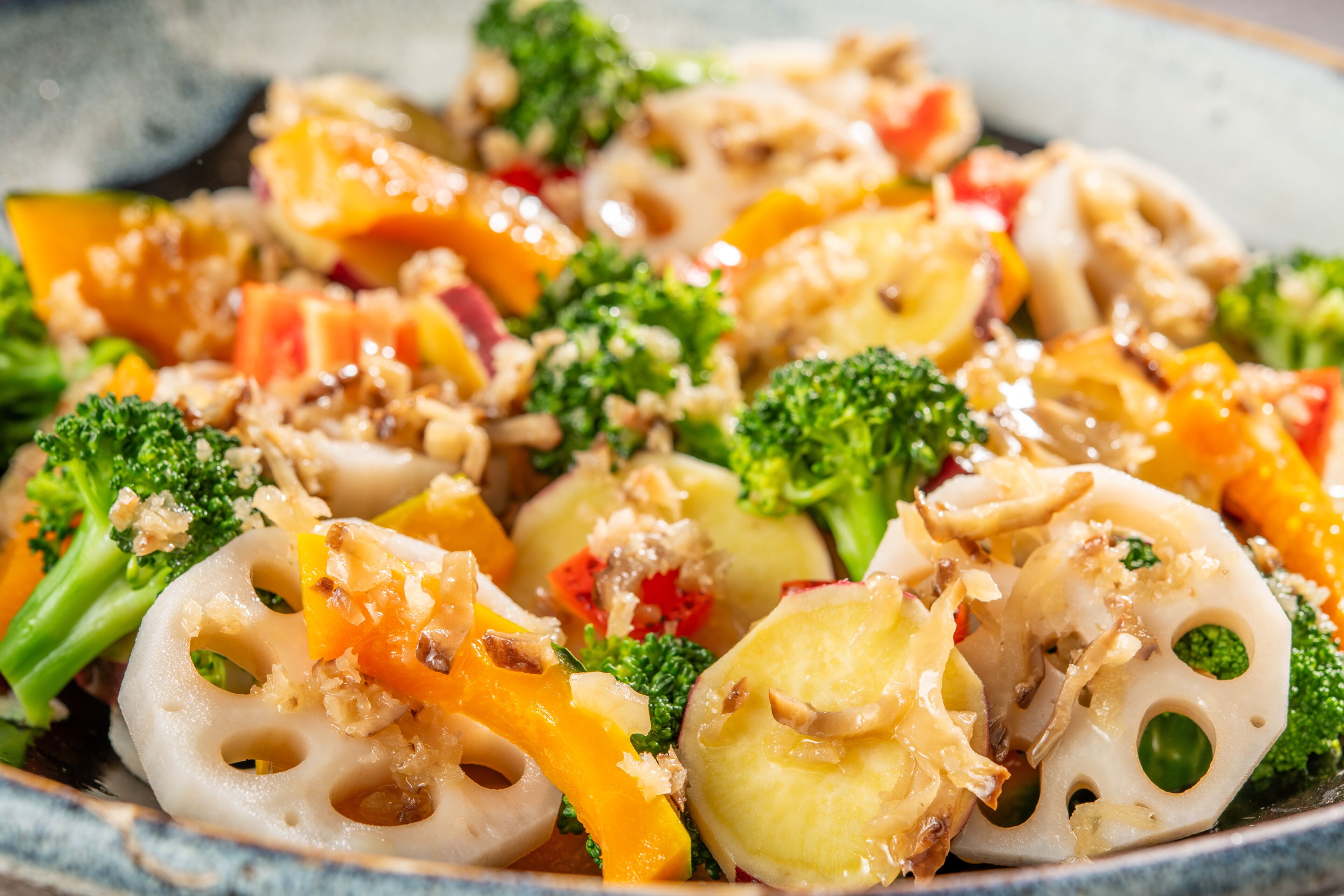 A close-up of a colorful vegetable stir-fry with broccoli, carrots, and other vegetables.