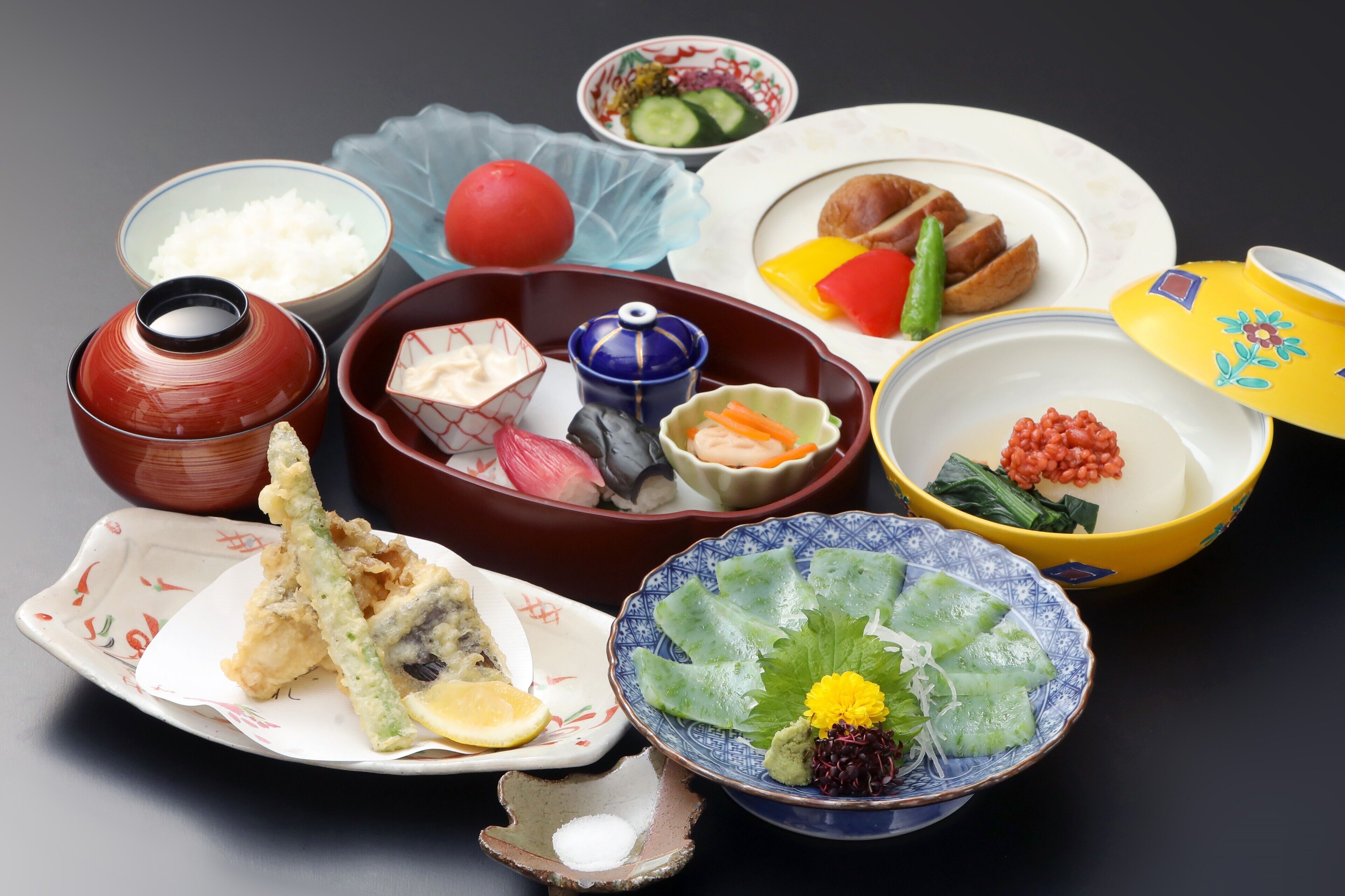 A variety of traditional Japanese dishes arranged on a table.