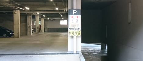 A parking garage with a sign indicating parking spaces 1 and 2.