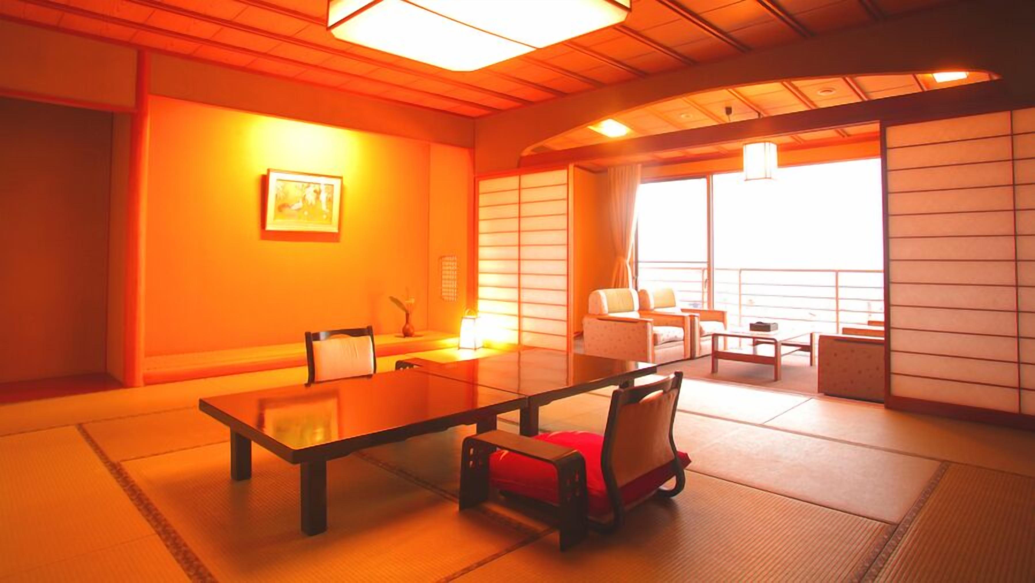 A traditional Japanese-style room with tatami flooring, a low table, and a sofa.