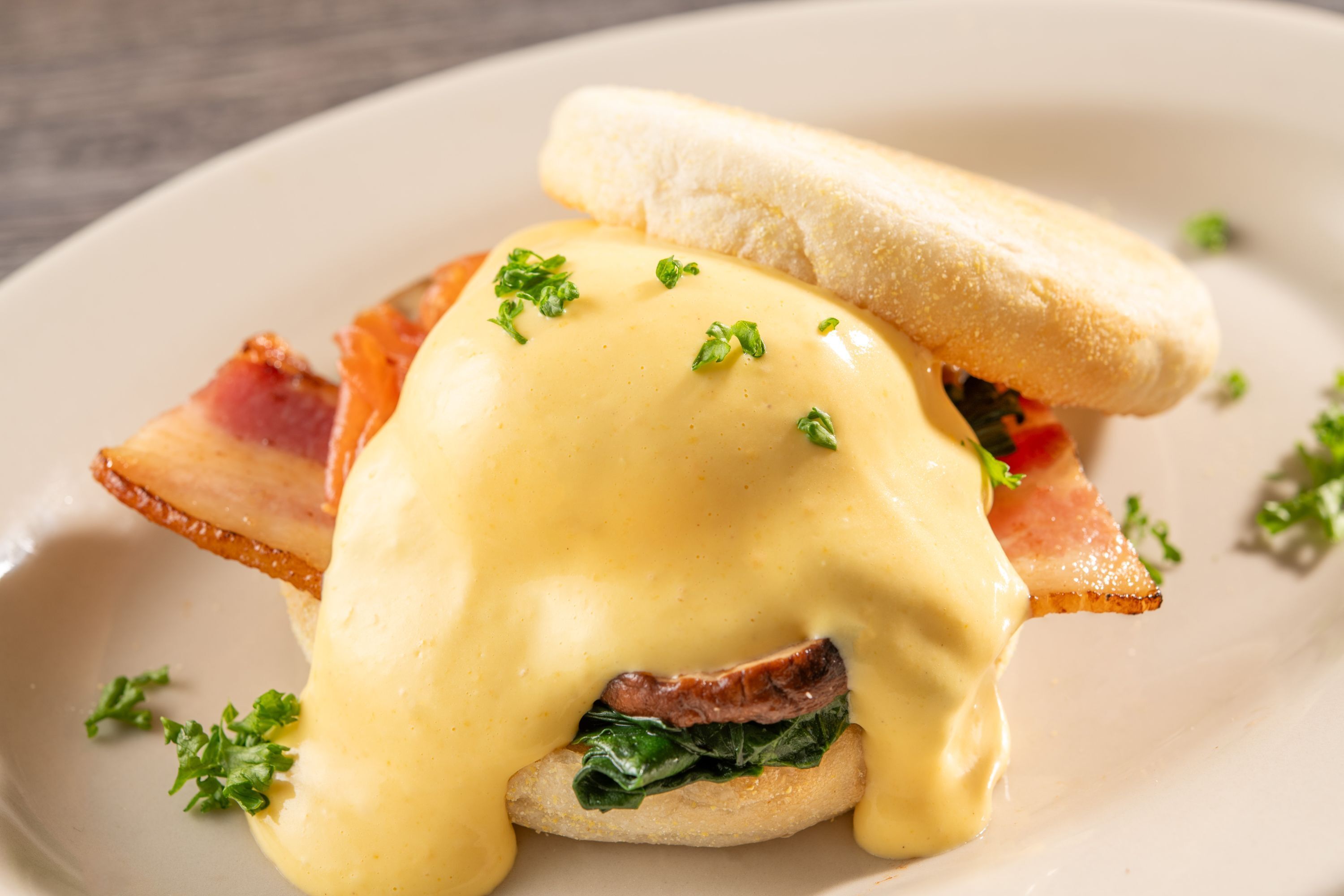 A breakfast dish with eggs, bacon, and greens.