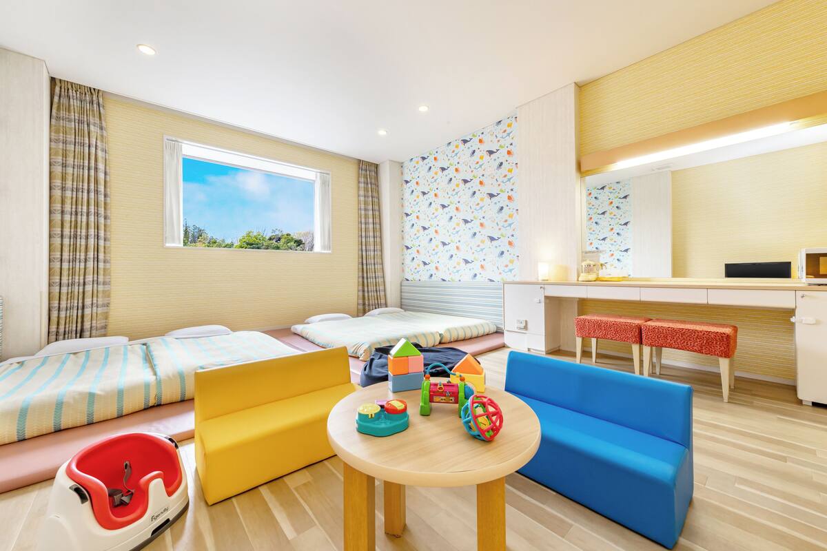 A children's play area with a sofa, a small table, and colorful toys.