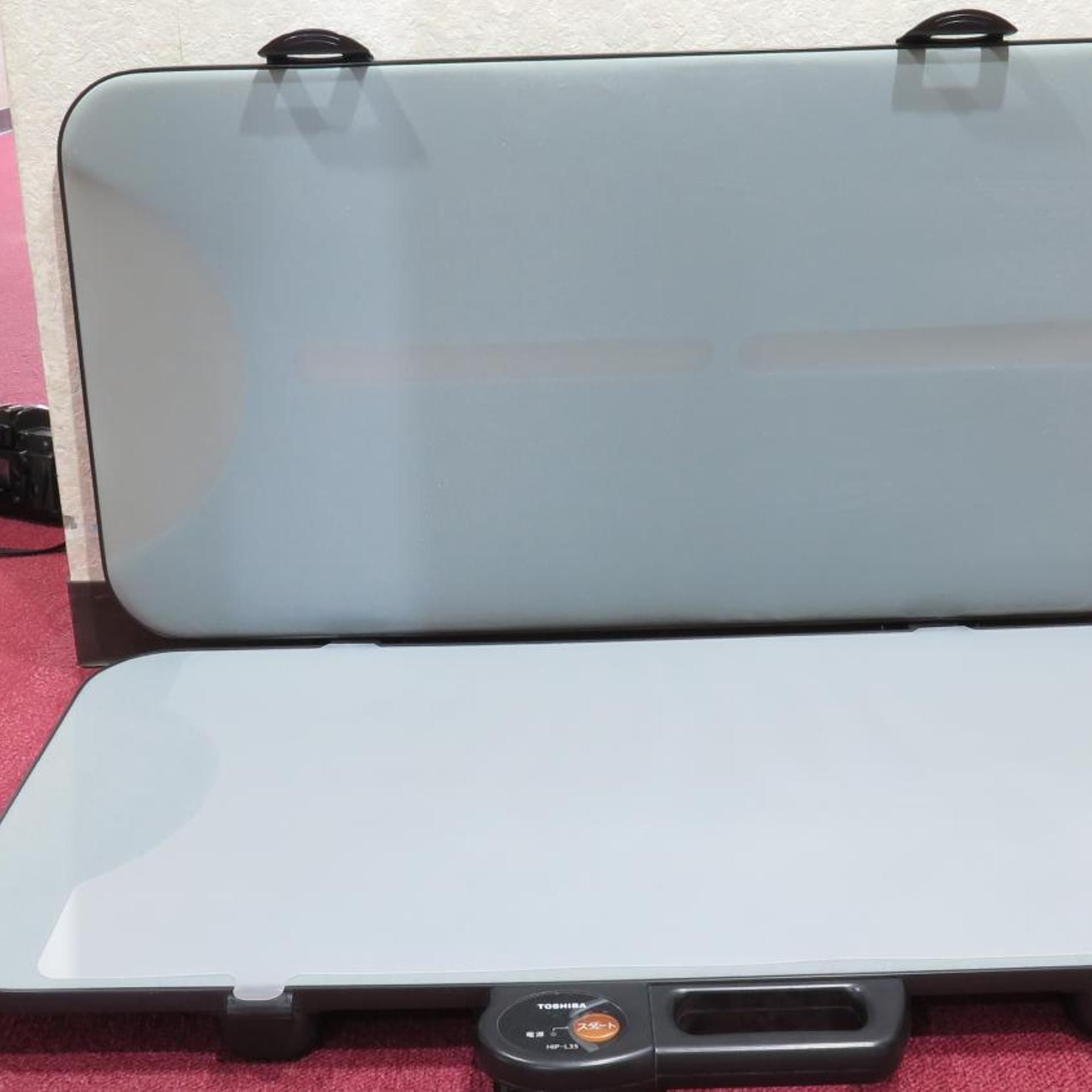 A closed laptop with a visible brand logo and a power button.