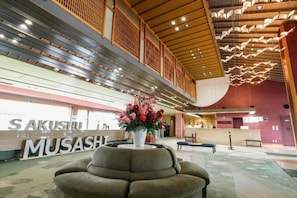 A lobby with a reception desk, a seating area, and a decorative ceiling. - Hotel Sakushu Musashi (Mimasaka)