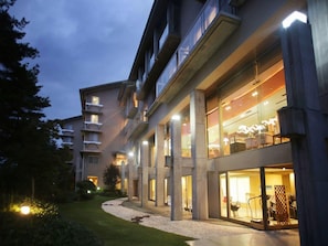 A multi-story hotel with a modern architectural design, featuring balconies and large windows. - Hotel Sakushu Musashi (Mimasaka)