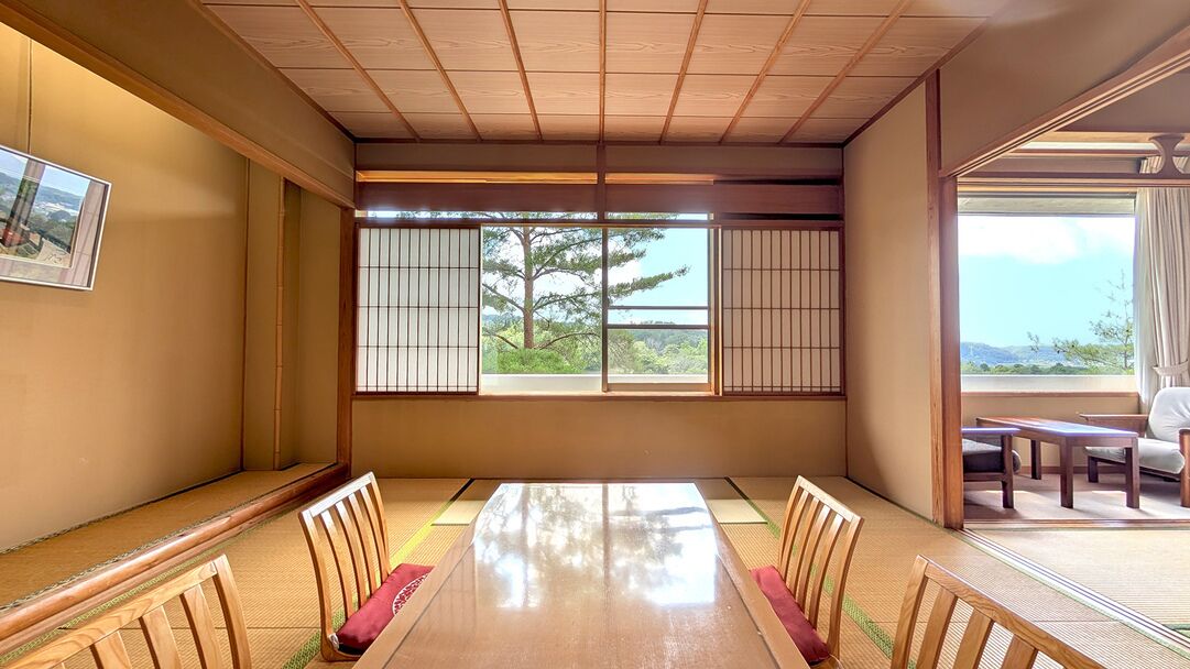 A traditional Japanese room with tatami flooring, a low table, and shoji screens.