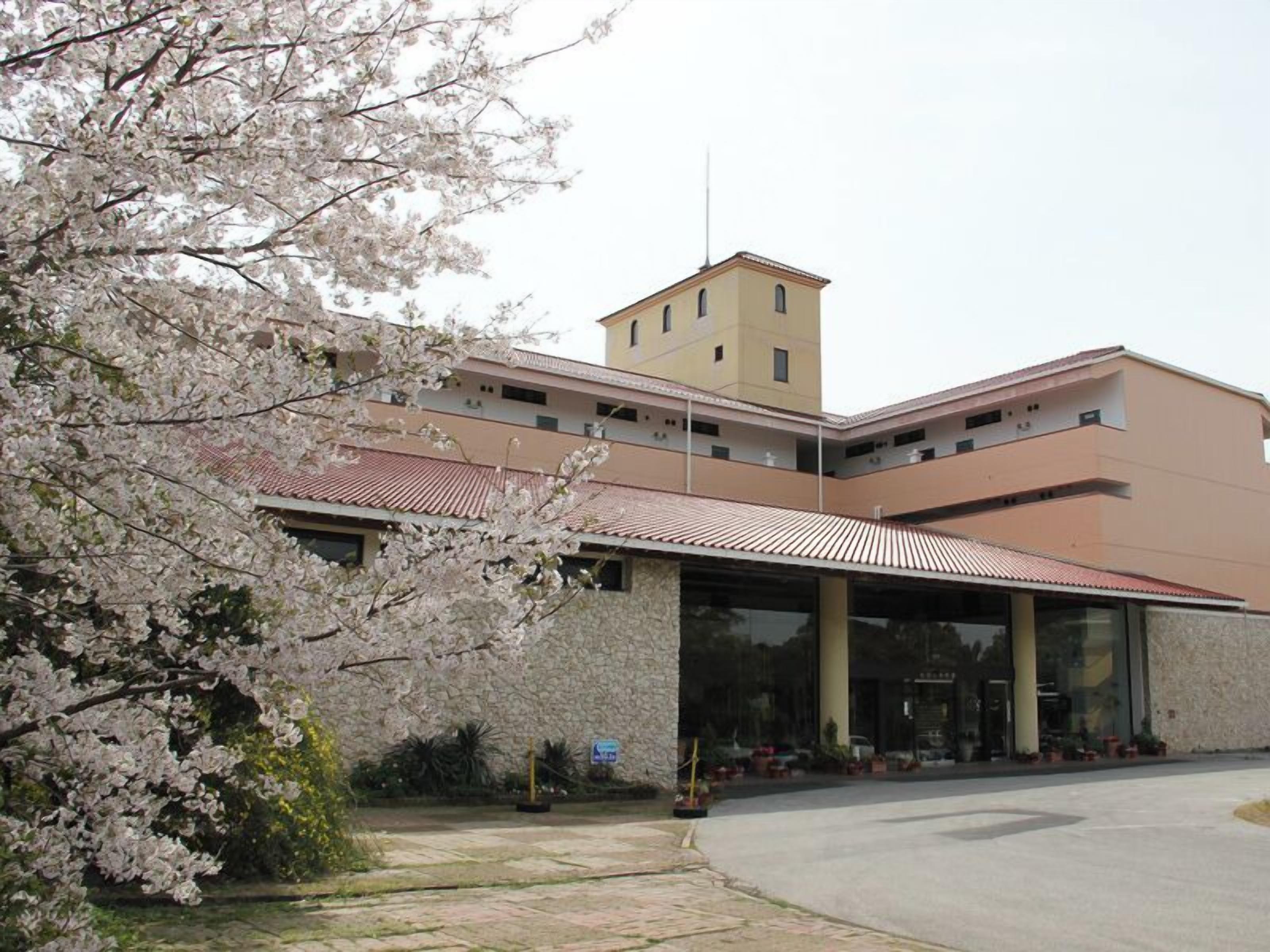 A building with a modern architectural style, featuring a flat roof and a mix of beige and brown colors.