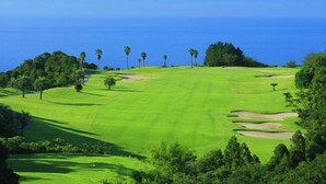 A golf course with a view of the ocean.