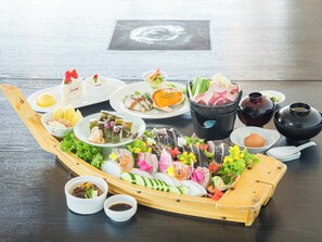 A traditional Japanese meal setup with various dishes and a wooden boat-shaped serving tray. - Resort Hotel Umibe no Kajuen (Konan)