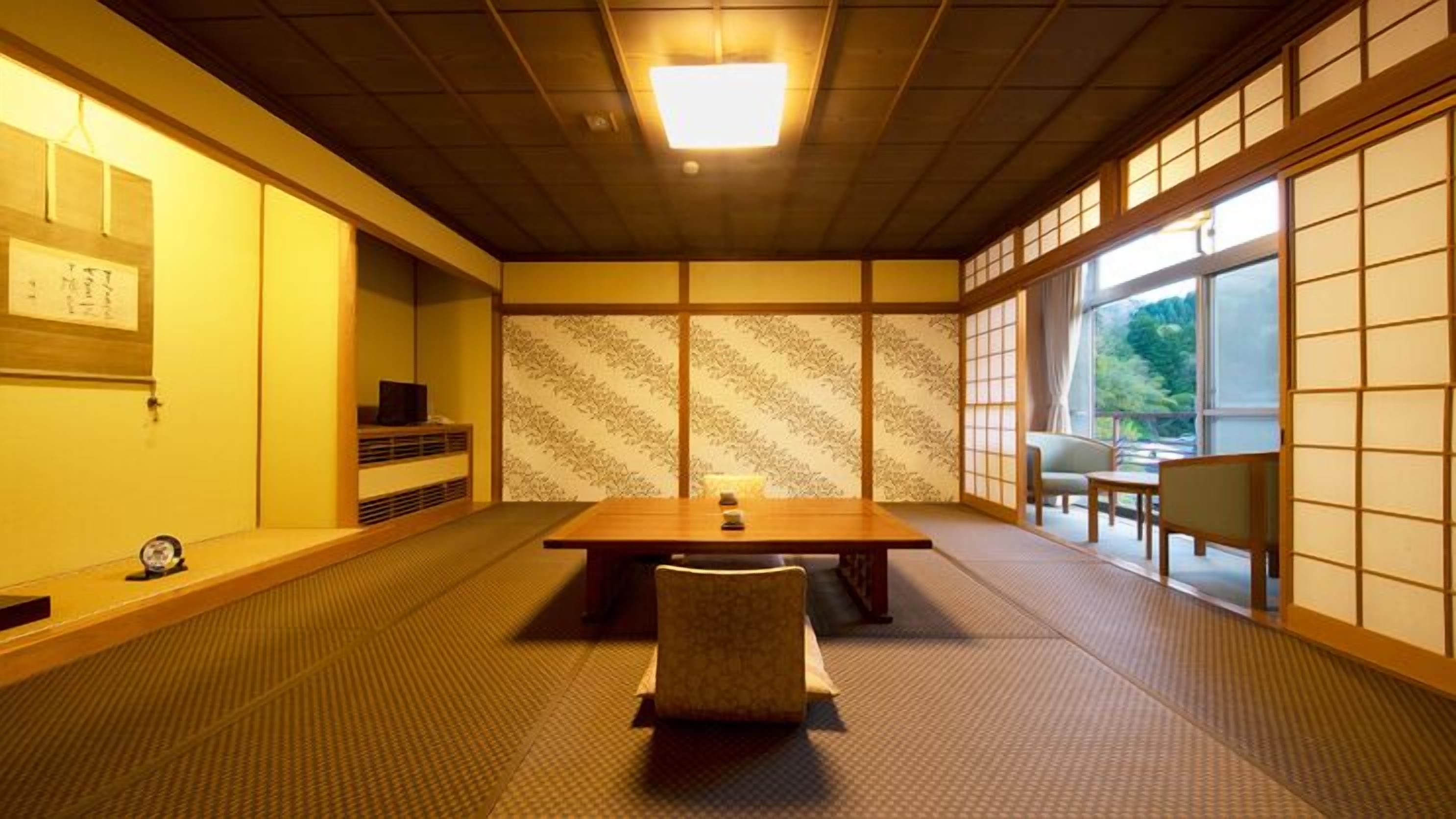 A traditional Japanese-style room with tatami flooring, a low table with cushions, sliding doors, and a view of greenery outside.