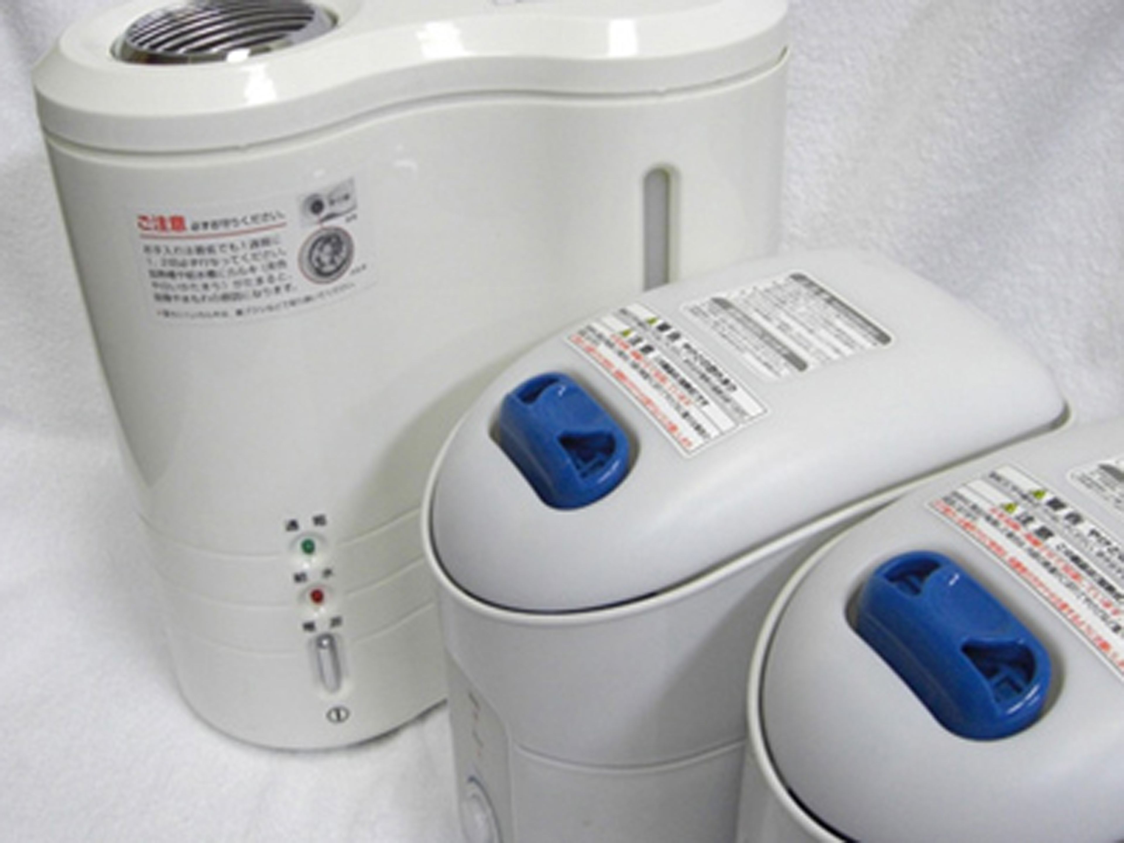 A white, modern-looking device with multiple buttons and a blue component.