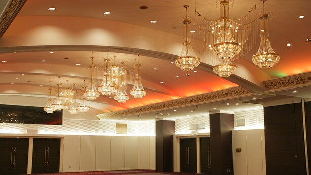 A spacious room with multiple doors, a patterned carpet, and ornate chandeliers. - Muroran Prince Hotel (Muroran)