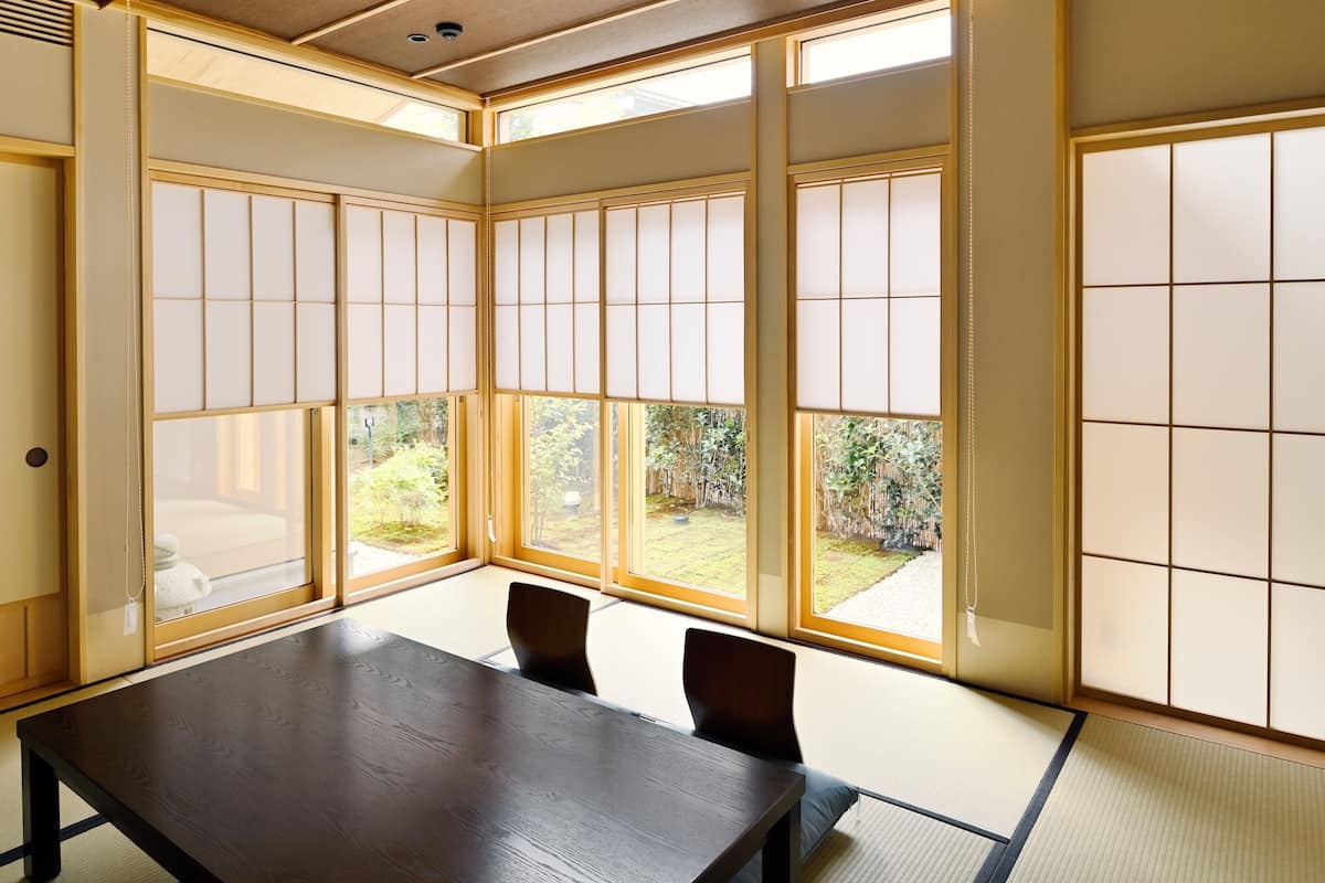 A traditional Japanese room with tatami flooring, a low table, and sliding shoji doors.