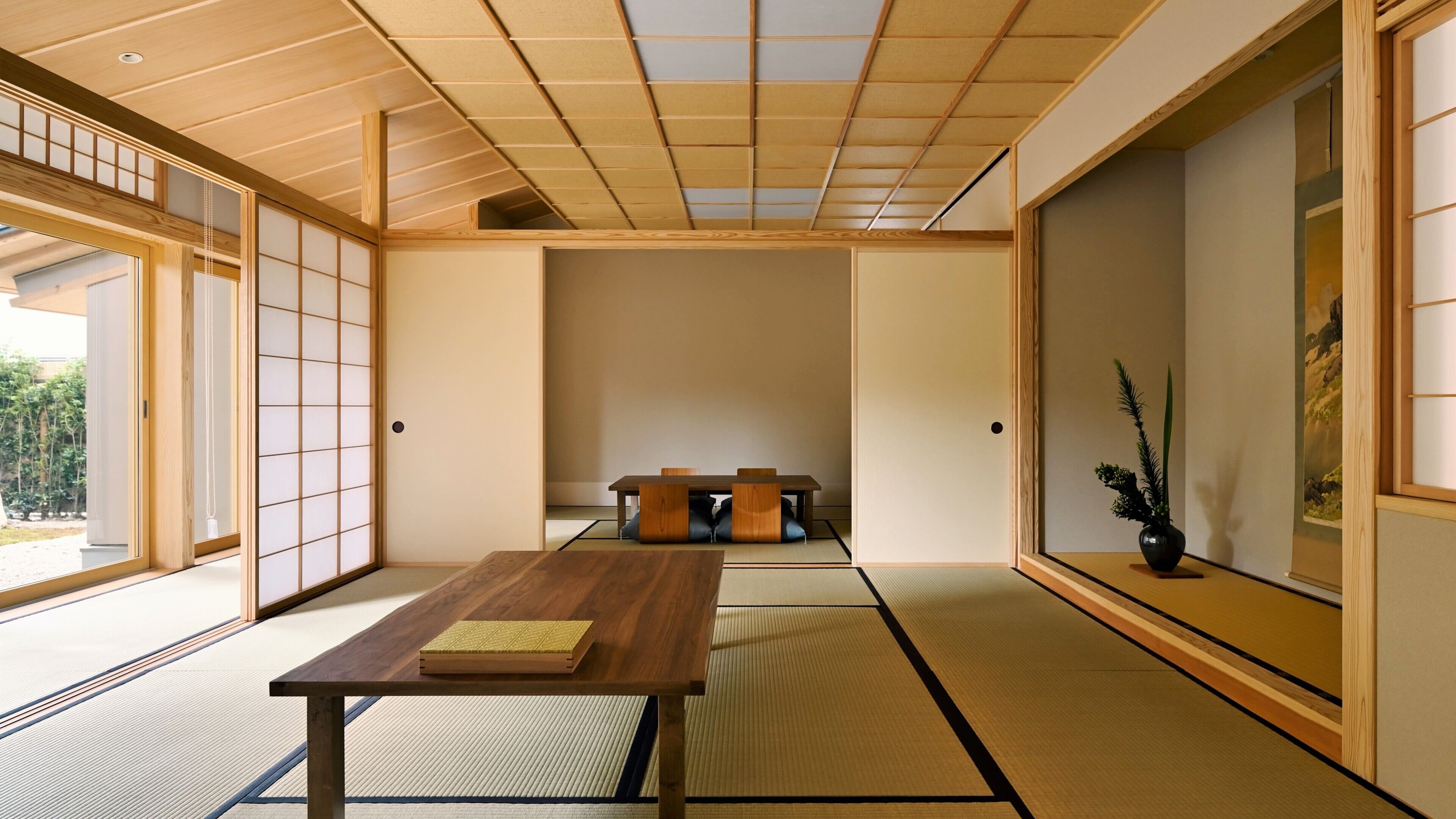 A traditional Japanese room with tatami flooring, a low wooden table, and sliding doors.