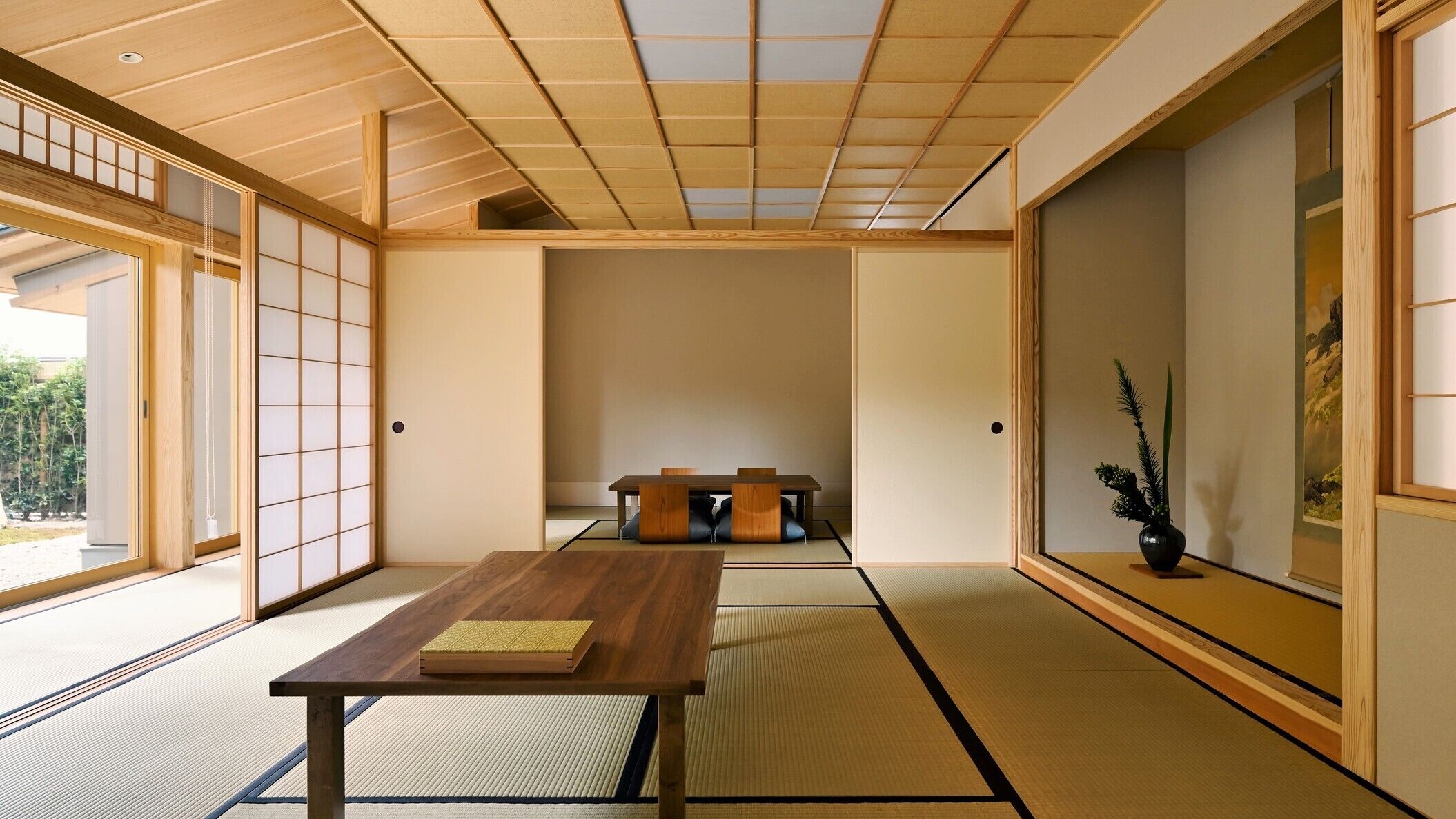 A traditional Japanese room with tatami flooring, a low wooden table, and sliding doors.