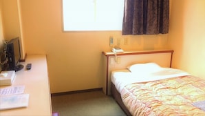 A hotel room with a bed, a desk with a computer, a telephone, and a window with curtains. - Matsue Plaza Hotel Annex (Matsue)