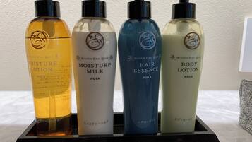 Four bottles of POLA products on a black display stand.