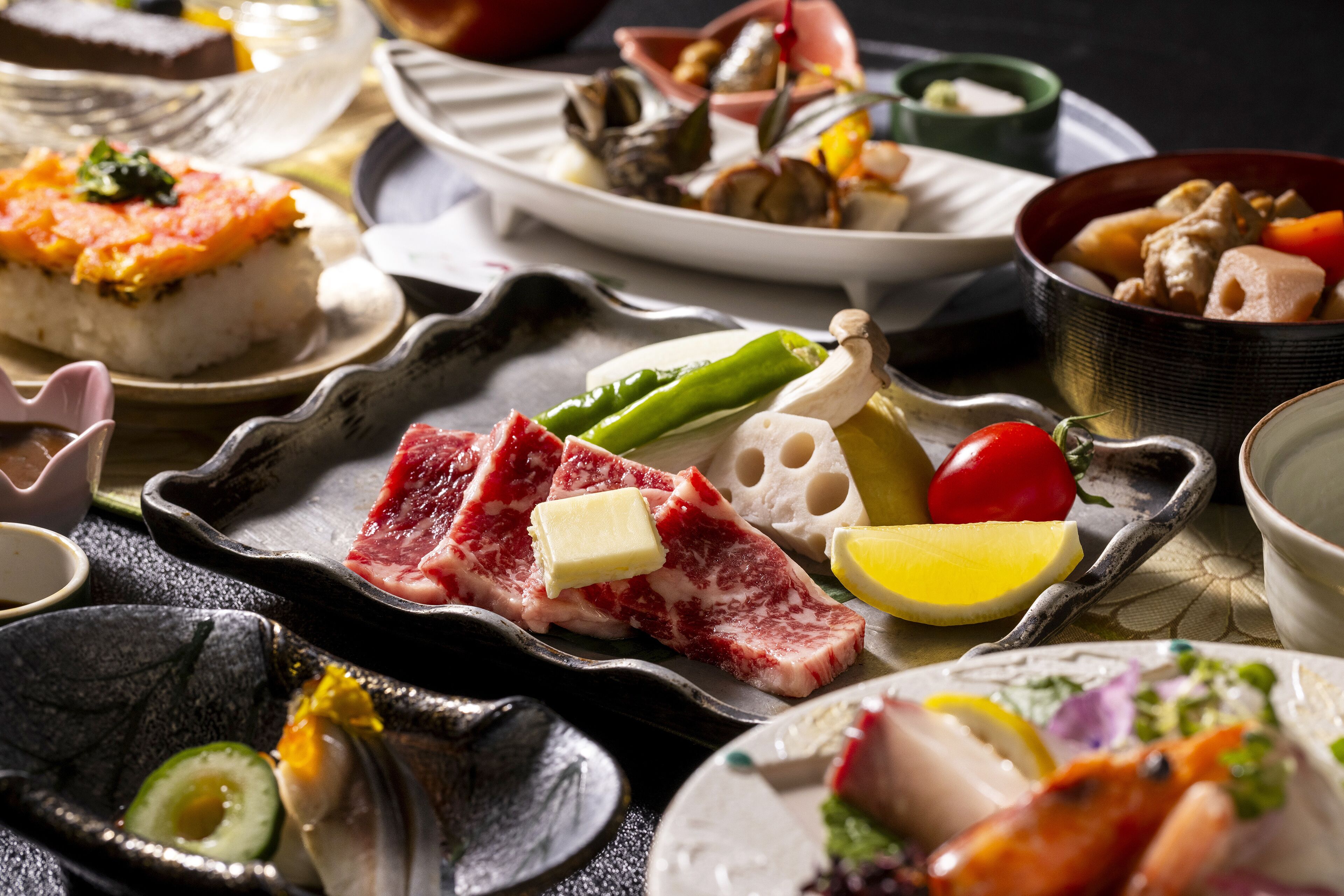A variety of dishes including sashimi, vegetables, and a bowl of meat.