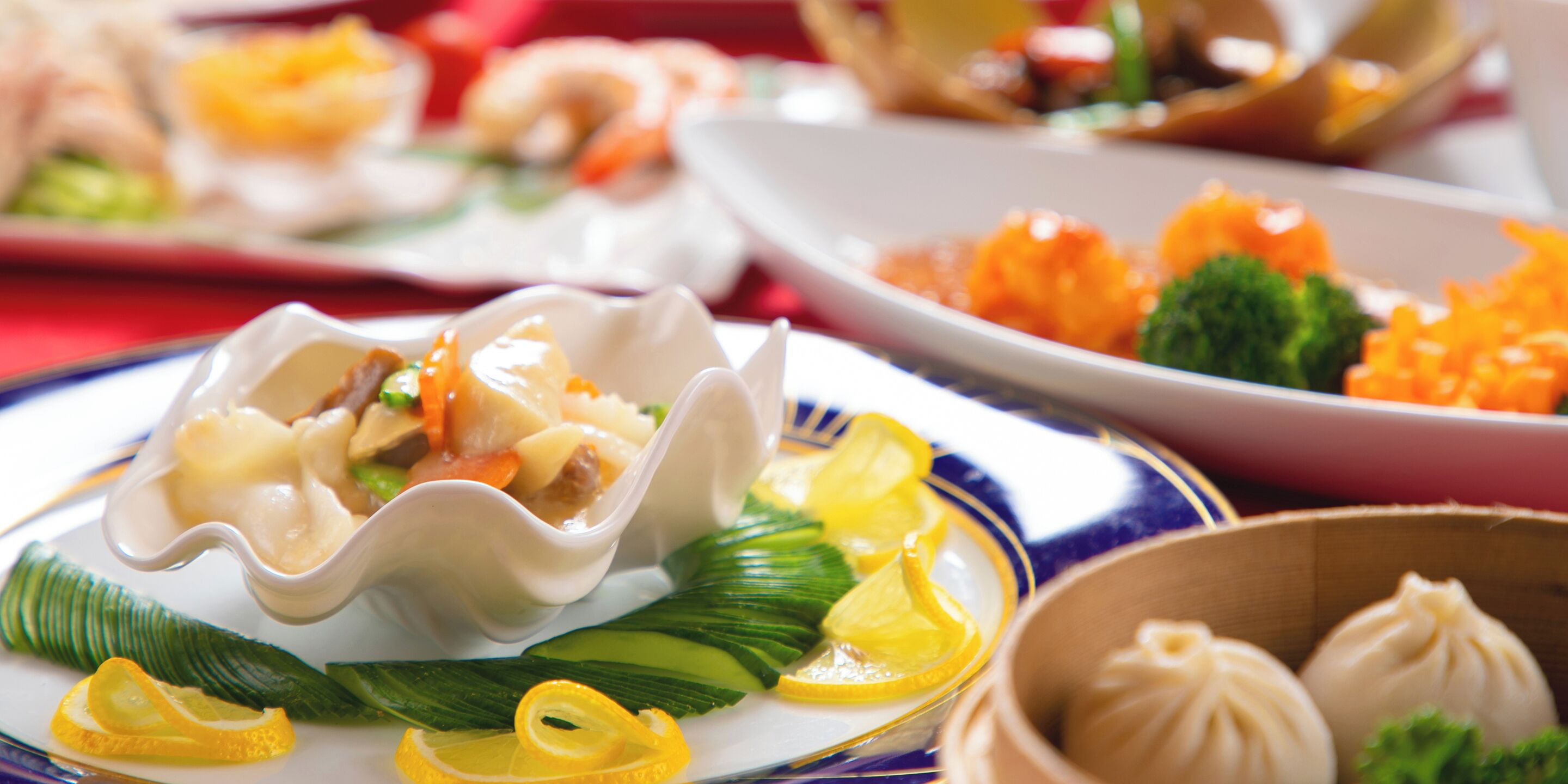 A variety of dishes including dumplings and vegetables on a table.
