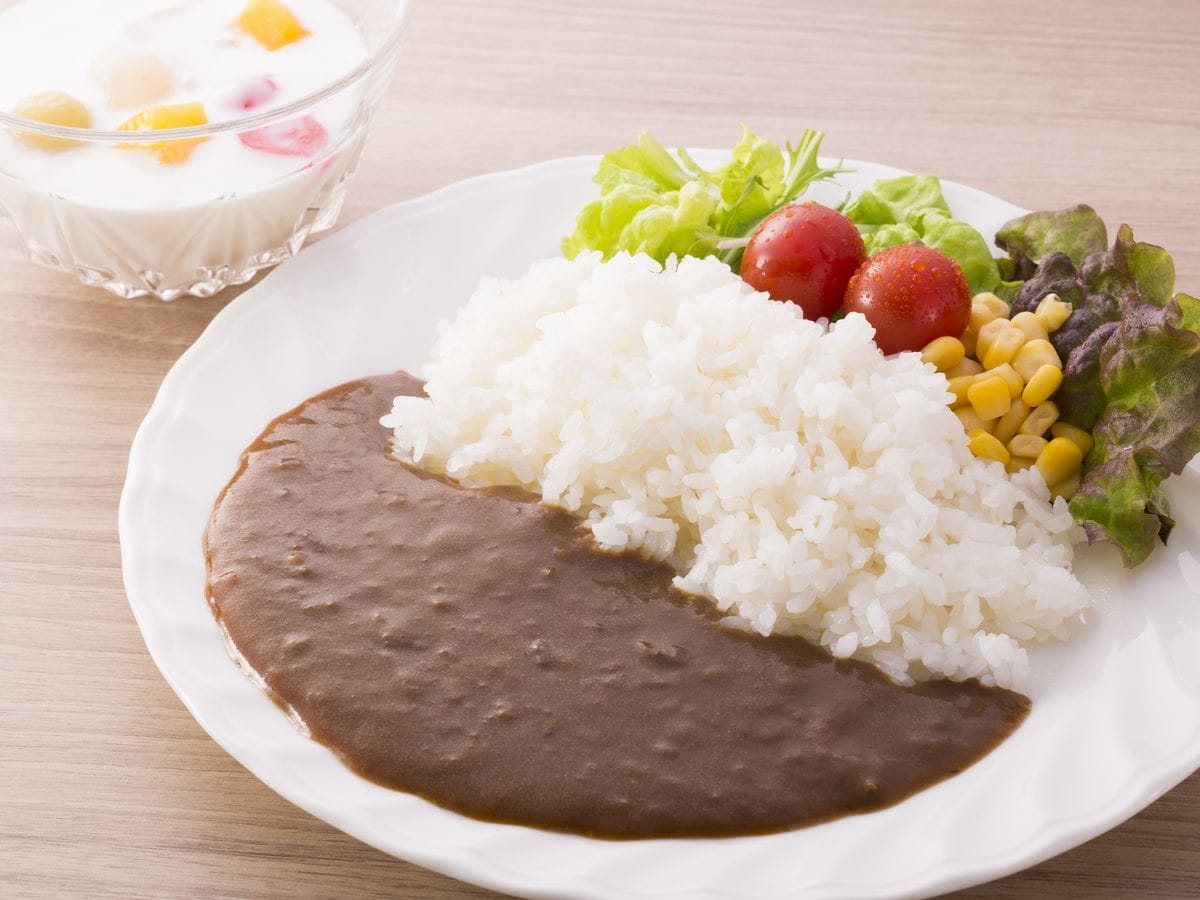 Ein Teller mit Reis, Bohnen und Salat.
