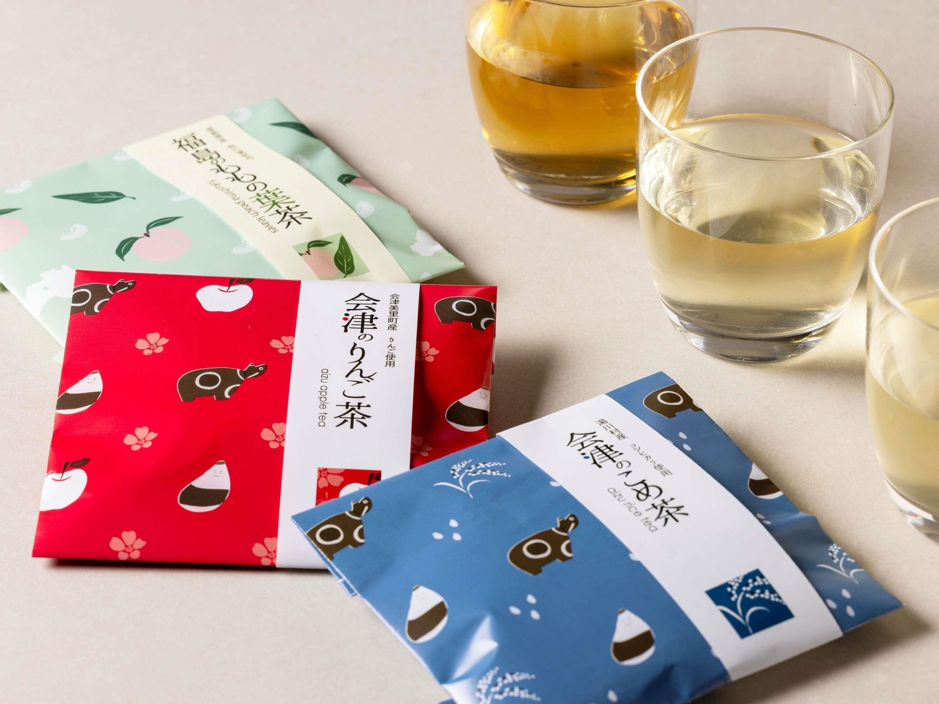 Tea bags with different patterns and a glass of tea.