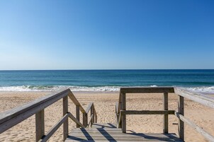 En la playa, sillas reclinables de playa, sombrillas, toallas de playa