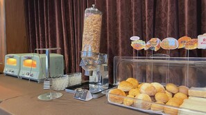 A breakfast buffet with various food items, a coffee machine, and a display of bread rolls. - Kokusai Daiichi Hotel (Oyama)
