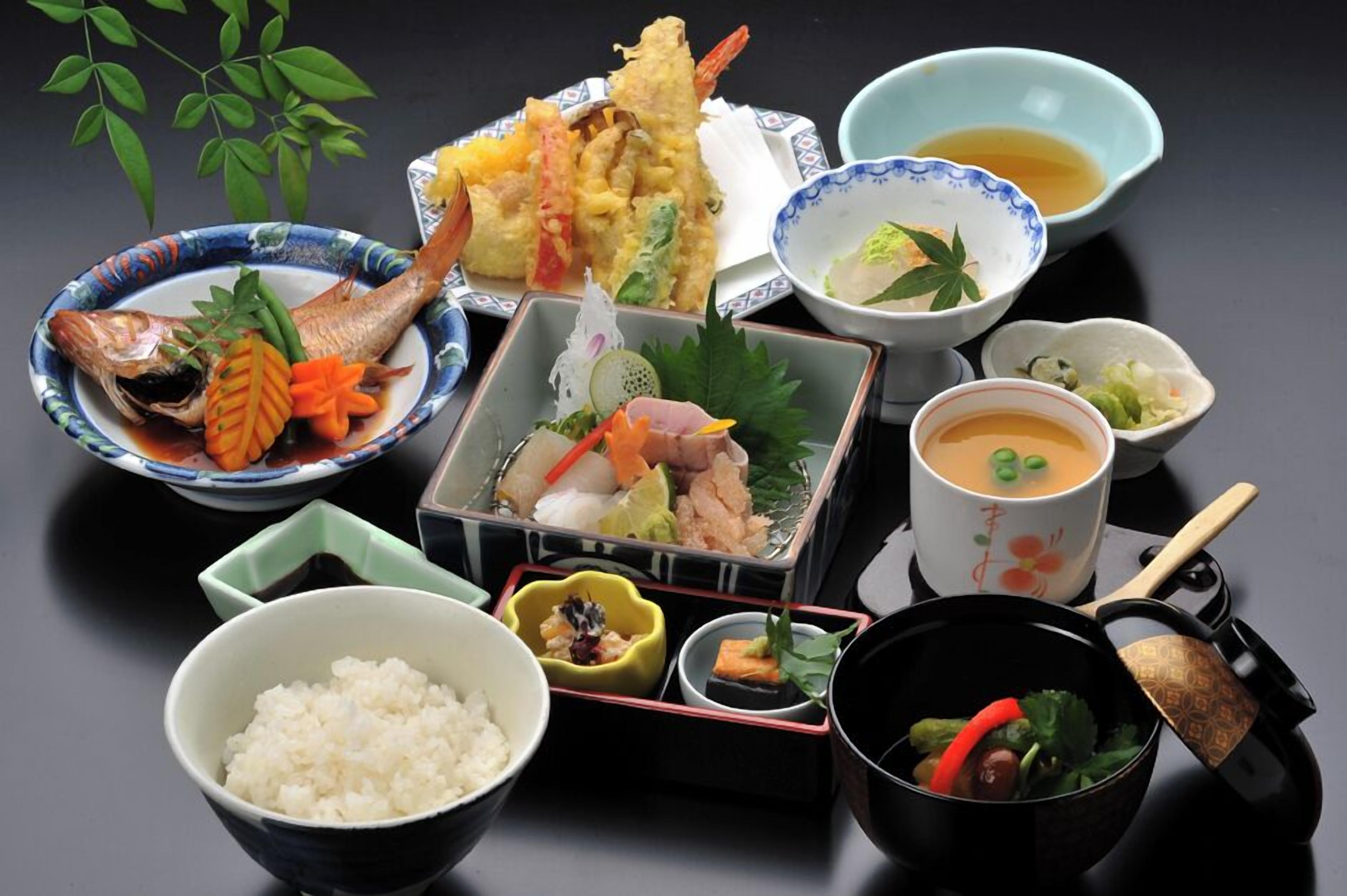 A traditional Japanese meal with various dishes and utensils.