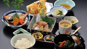 A traditional Japanese meal with various dishes and utensils.