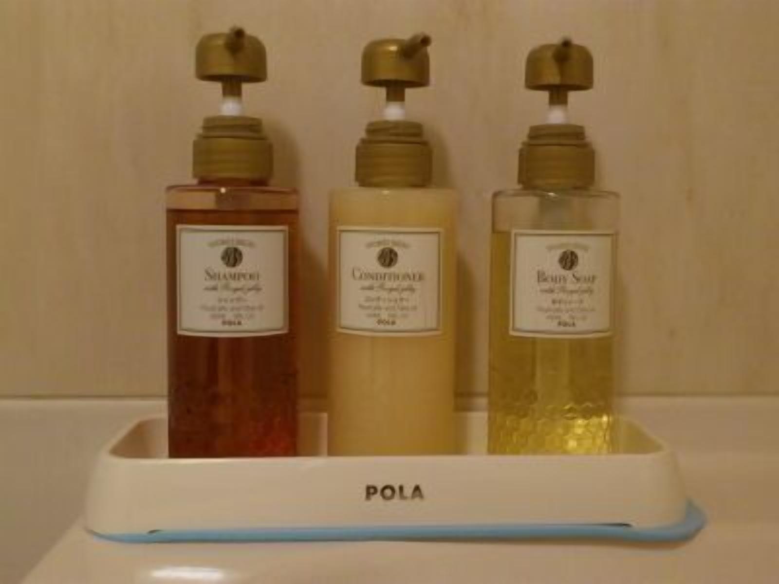 Three bottles of liquid on a white tray labeled 'POLA'.