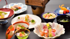 A variety of Japanese dishes arranged on a table, including sushi, sashimi, and other seafood delicacies. - Kansuitei Kozeniya (Tottori)