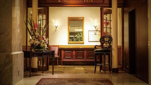 A lobby with a reception desk, a bench, and a sign for 'GRILL YASHIMA'.