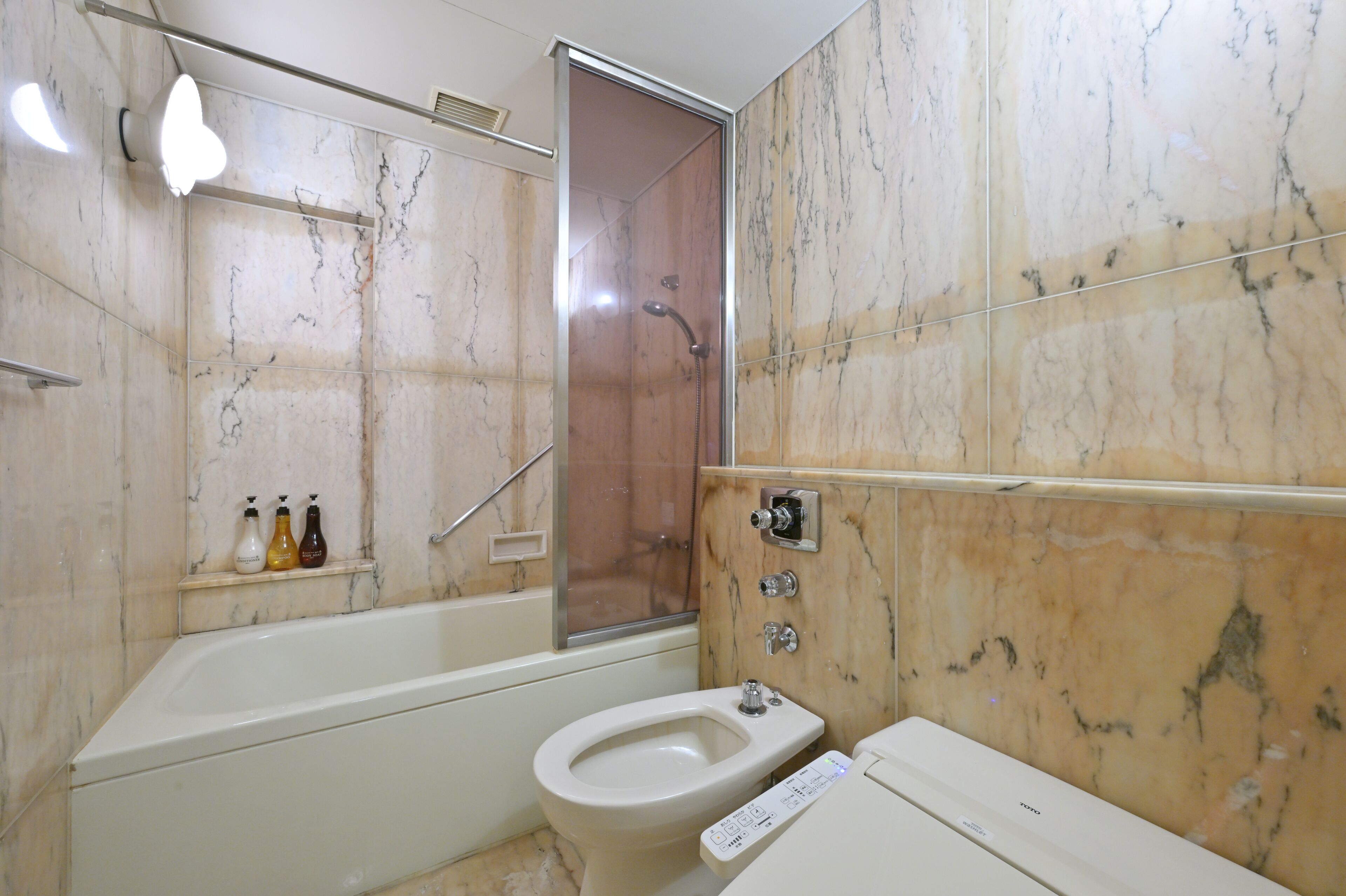A bathroom with a bathtub, a shower, a toilet, and a sink.