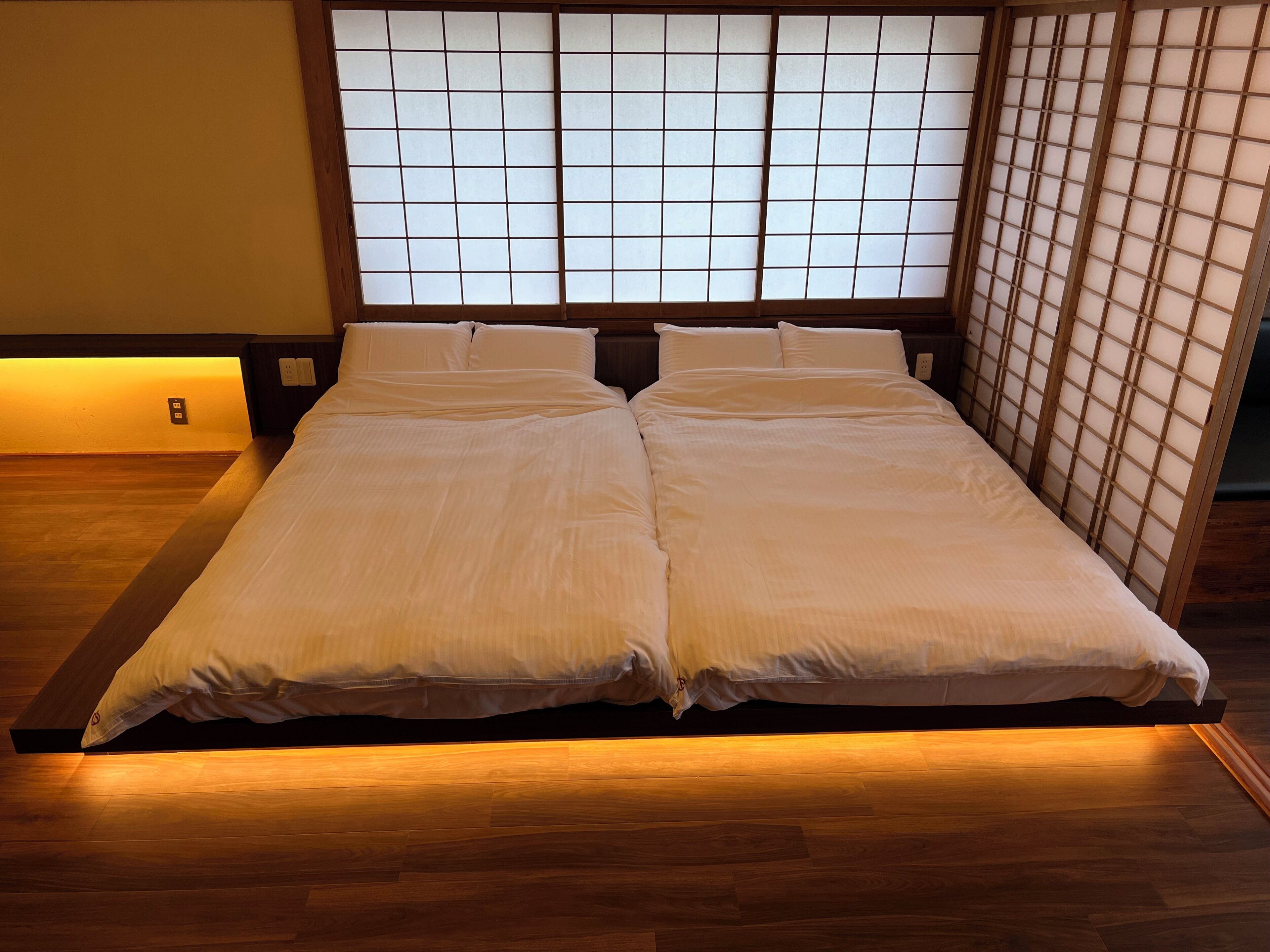 A bed with a wooden frame and a headboard with a grid pattern.