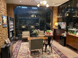 A cozy room with a brick wall, a sofa, a coffee table, and a decorative rug.