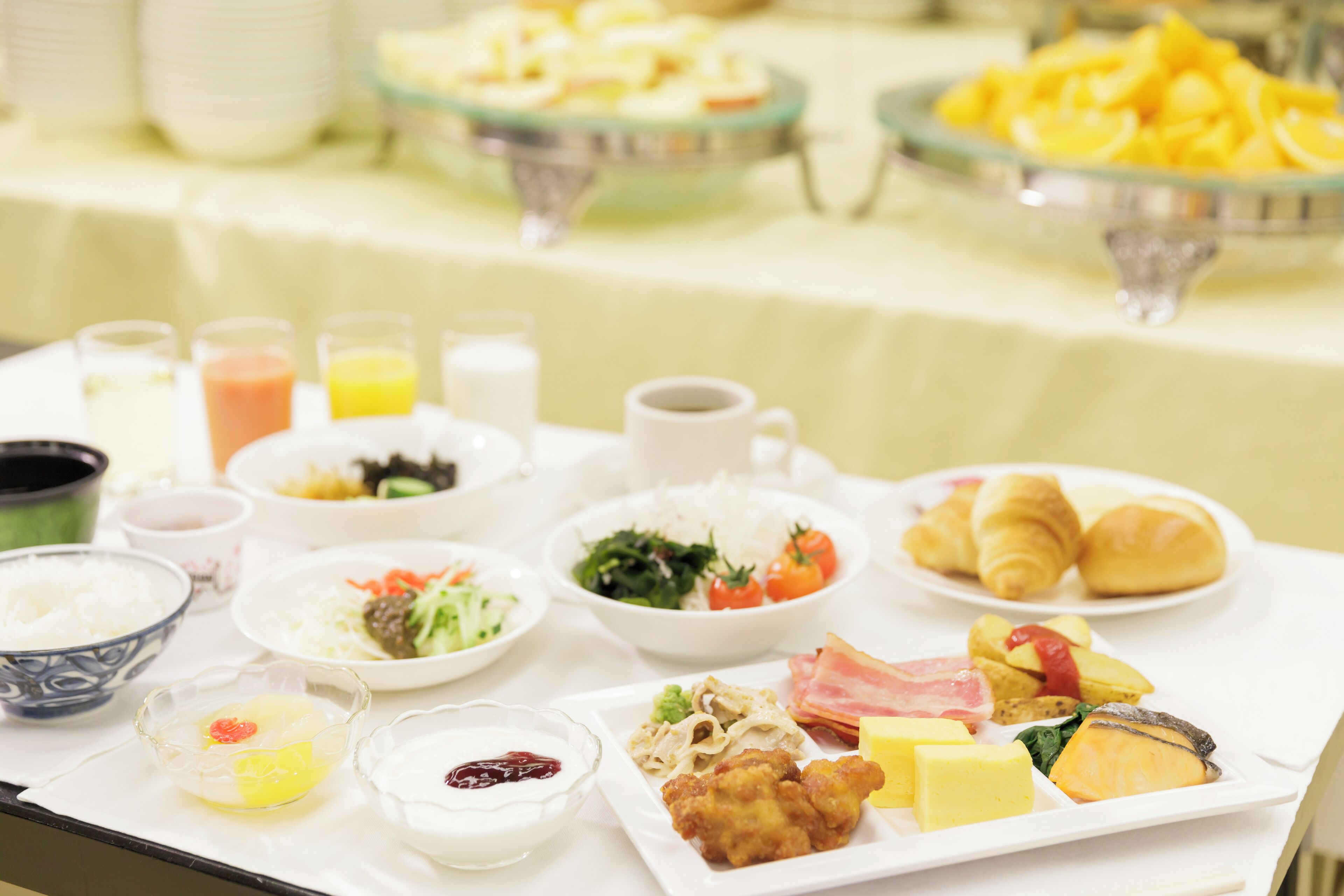 A buffet with various dishes including rice, vegetables, and meats.