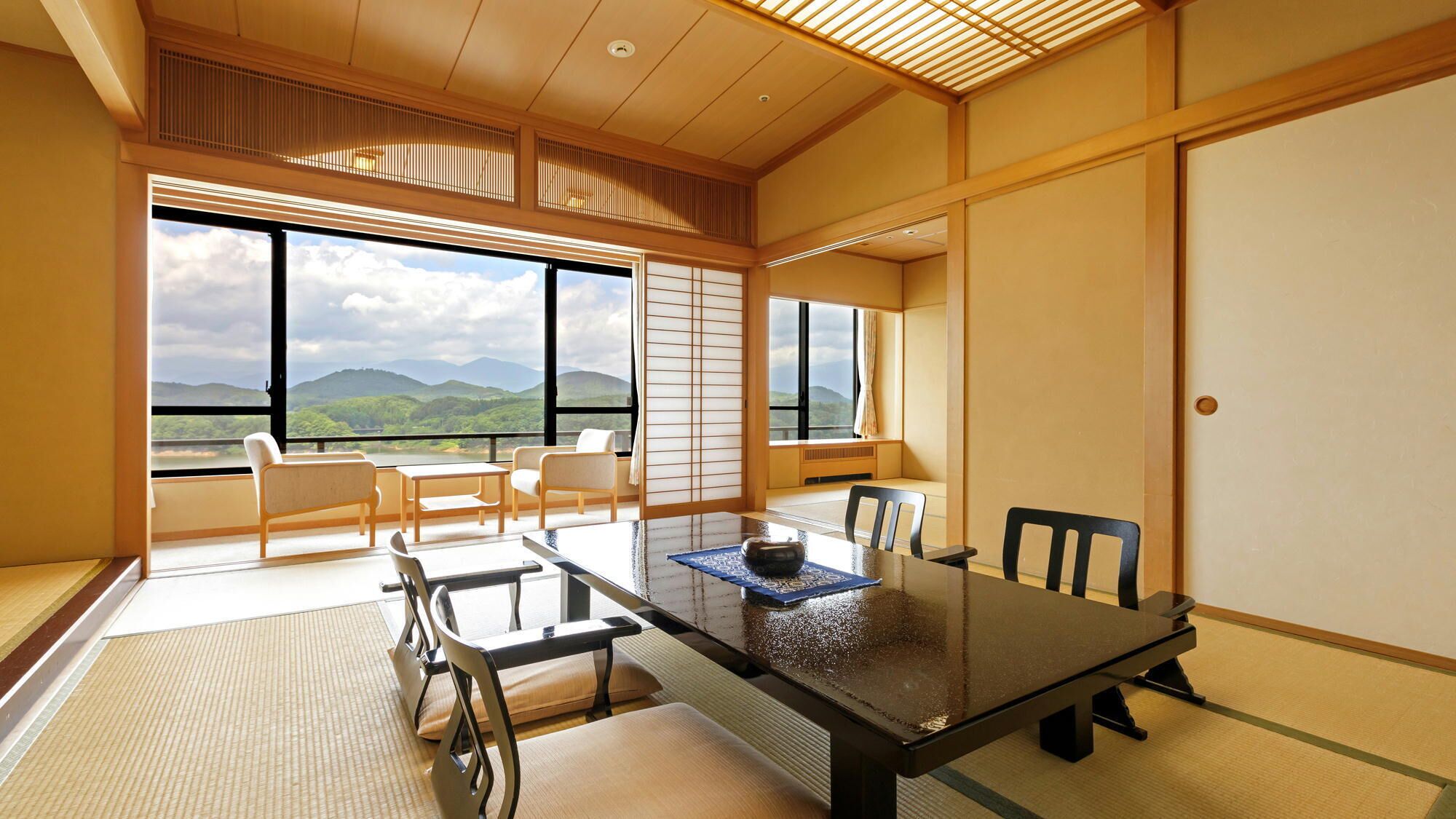 A traditional Japanese-style room with tatami flooring, a low table, and sliding doors.